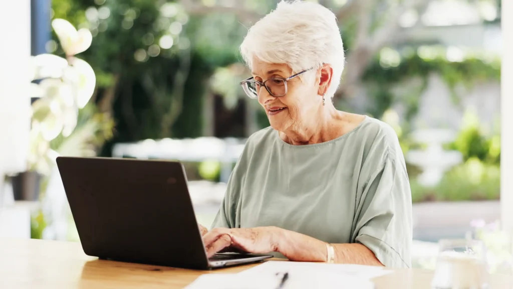 Person sitting outside using a laptop