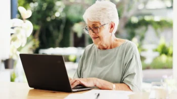 Person sitting outside using a laptop