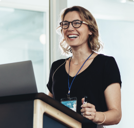 Woman at a podium smiling