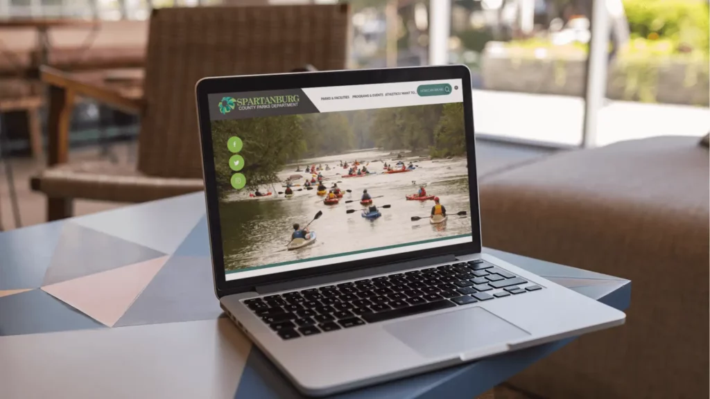 Laptop on a table displaying the Spartanburg County, South Carolina website