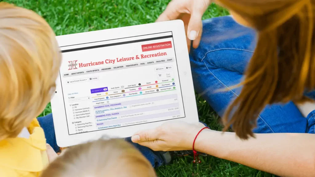 Children looking at the Hurricane City Leisure and Recreation website on a tablet