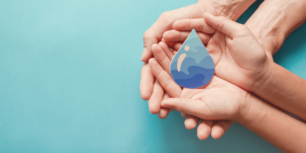 Group of hands holding a picture of a water drop