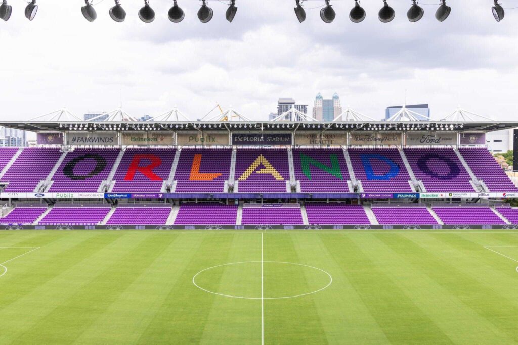 The field and emplty stand in Exploria Stadium Orlando, the word Orlando is spelled in the stands in rainbow colors