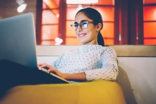 Woman working in a relaxed position on a couch