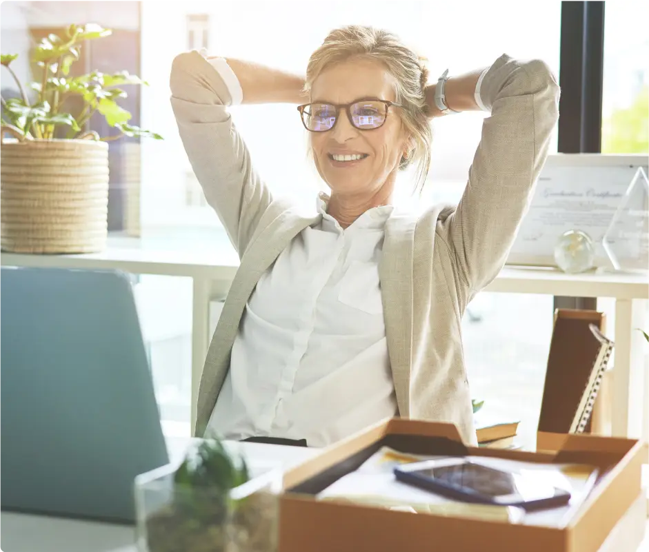 A woman at her work desk smiling