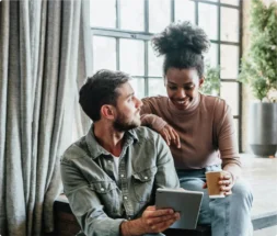 Man and woman looking at a tablet together