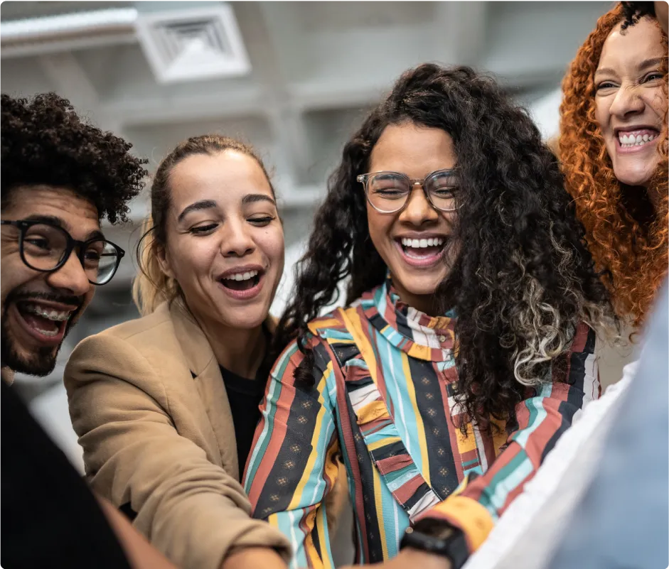 A group of people standing together and laughing