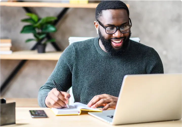 A man happily working on the laptop