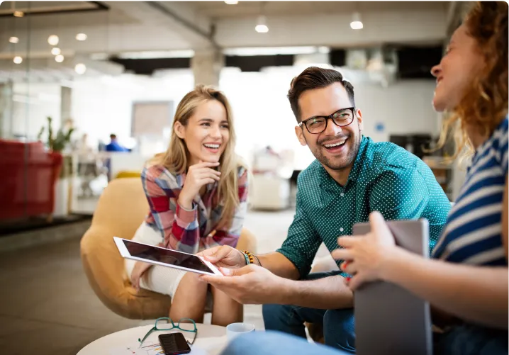 Group of co-workers having a light-hearted chat in office