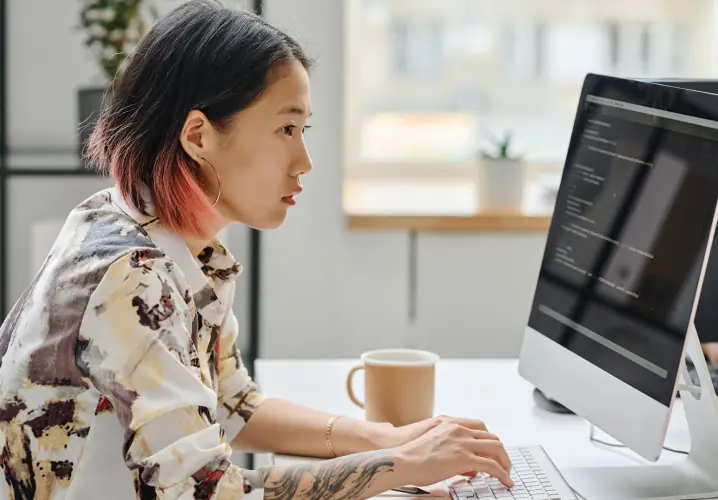 Girl working on a personal computer at her desk