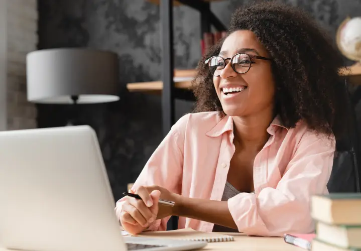 Woman at her work desk, smiling