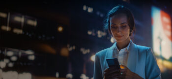 Woman looking at her phone smiling