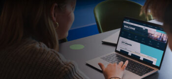Woman at a desk working on a laptop