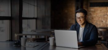 Man working on a laptop at a coffee shop
