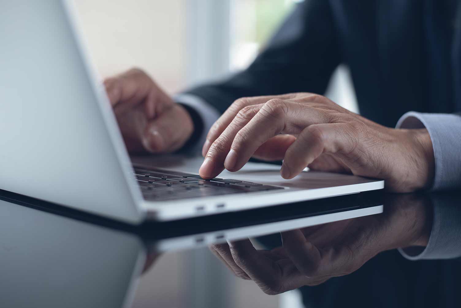 Hands typing on a keyboard