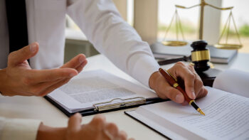 People reading documents with a gavel in the background