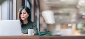 Portrait of Young Asian Woman Working on Laptop