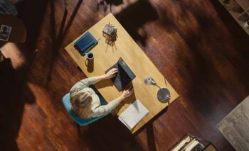 Person working at their desk from above