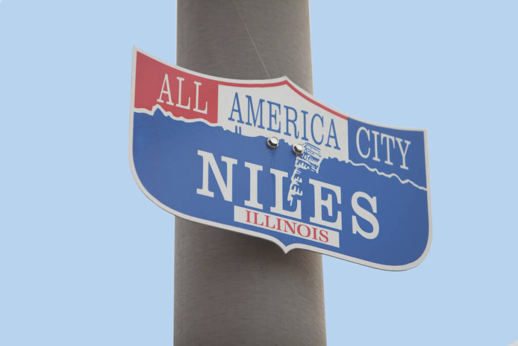 sign with town name on a street post in Niles, Illinois