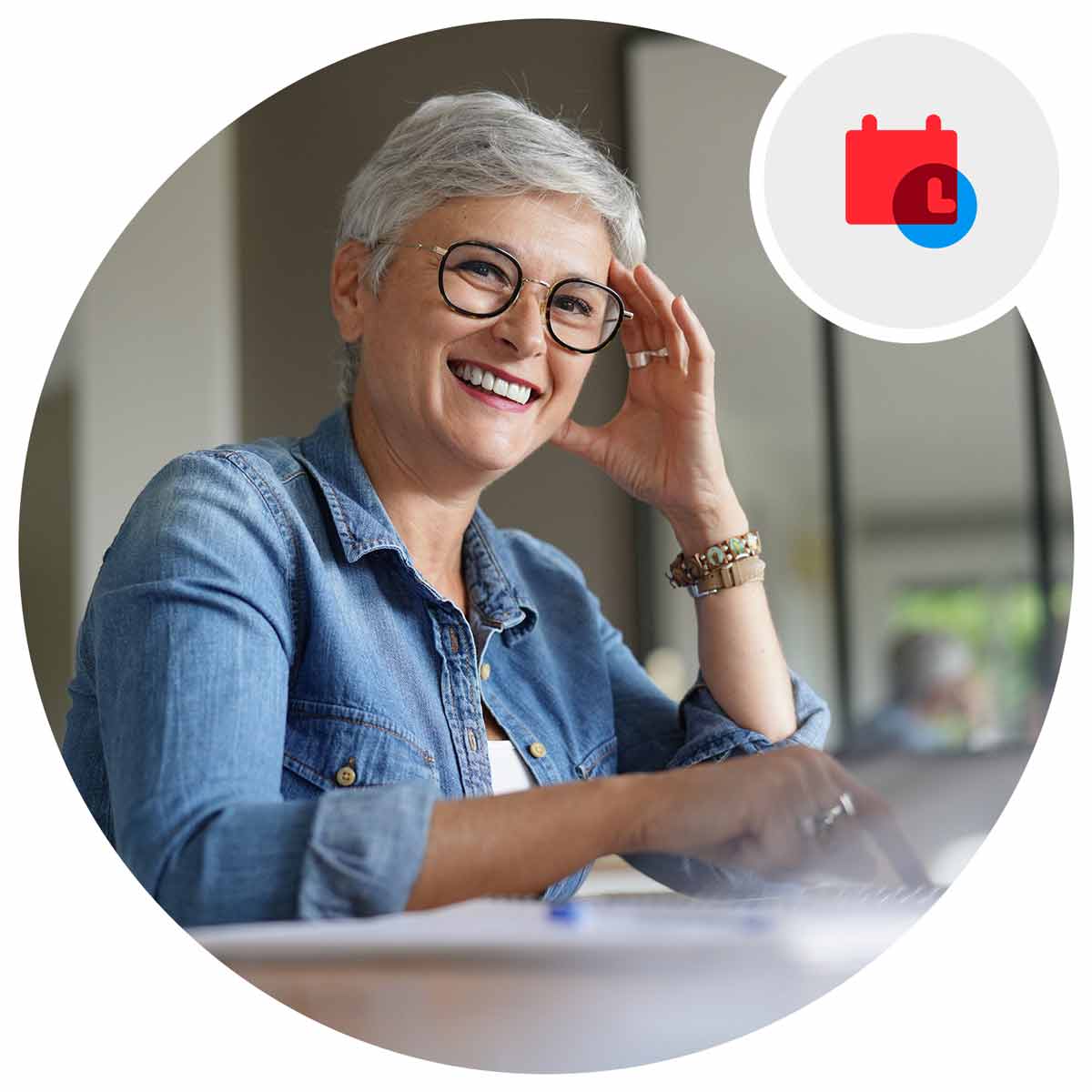 Woman smiling working on a laptop