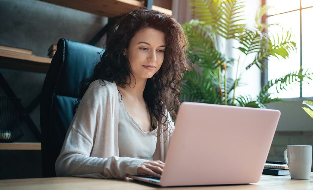 Woman using computer at home