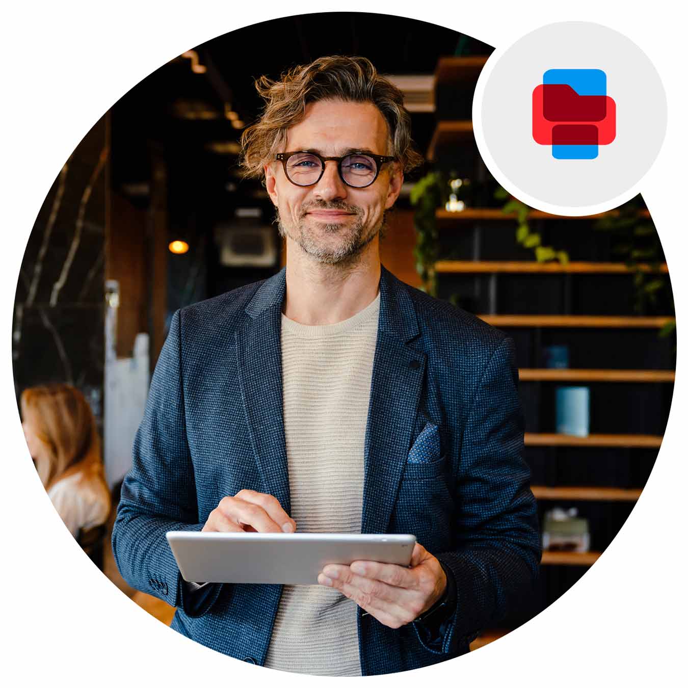 Man using a tablet with an office in the background