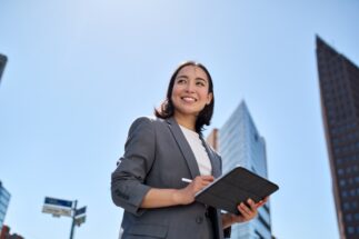 Person looking up and smiling with tablet in hand