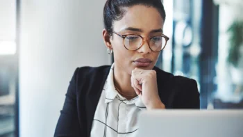 Employee wearing glasses looking at a screen