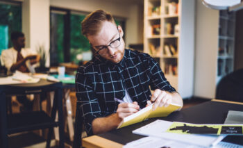 student with notebook at a desk
