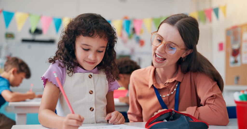 woman and young child sitting at a table looking at a draw pad.