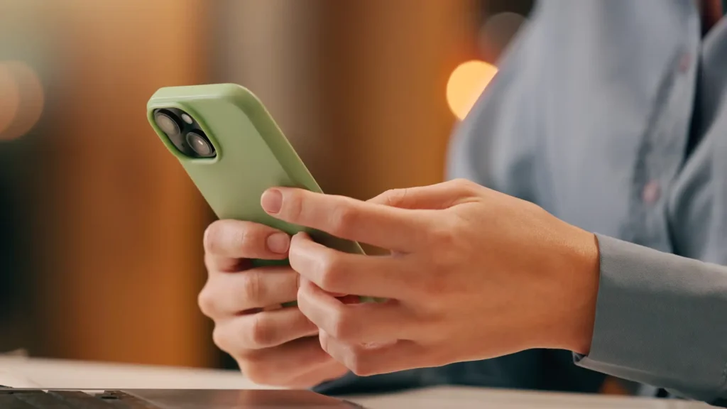 Woman's hands holding a cell phone