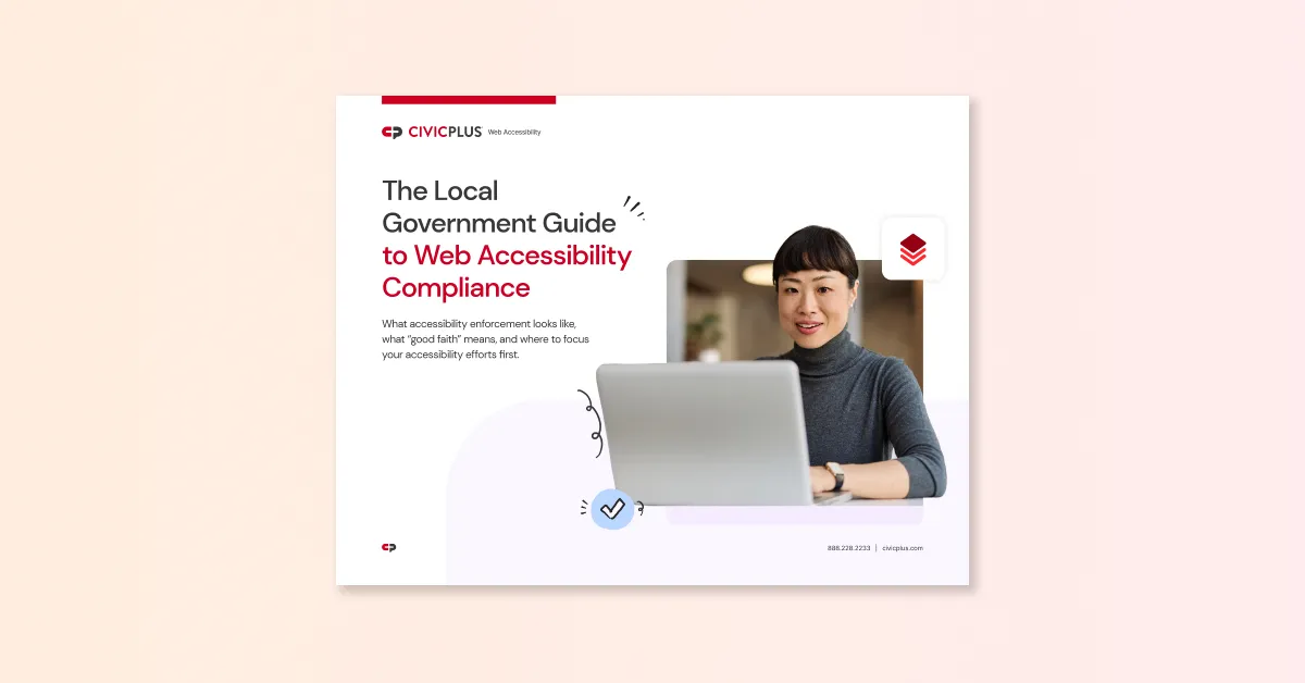 woman sitting at desk typing on laptop computer