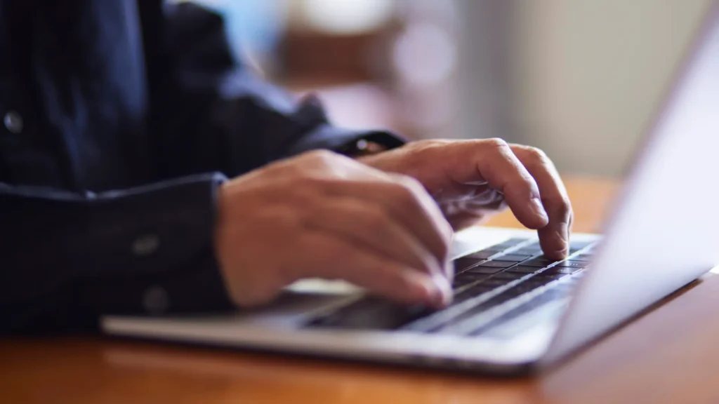 hands on a laptop keyboard
