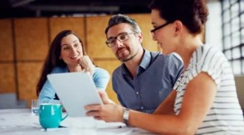 Group at a table looking at a tablet