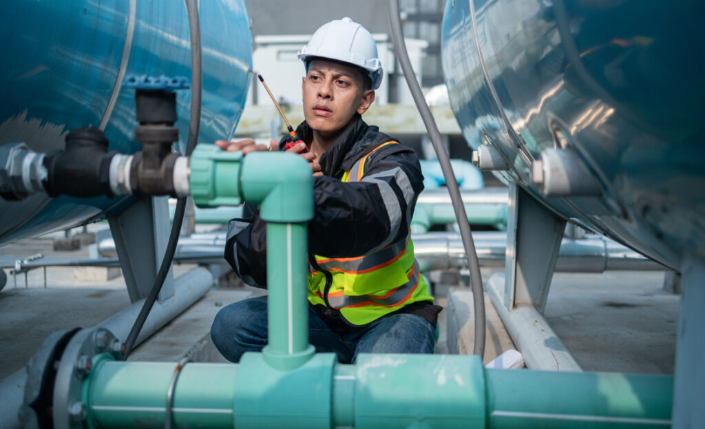 Man inspecting pipe