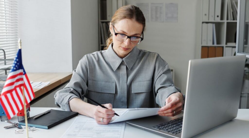 Professional at her computer with a flag on the desk