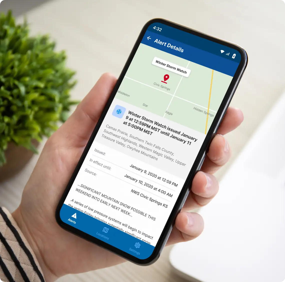 Person holding a cellphone that shows a map and location icon.