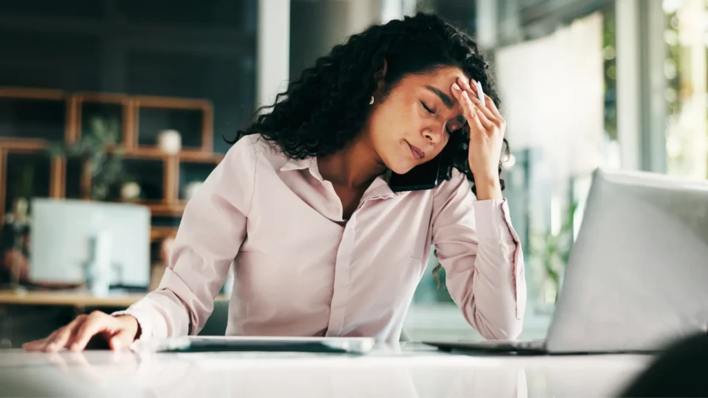frustrated customer holding her head