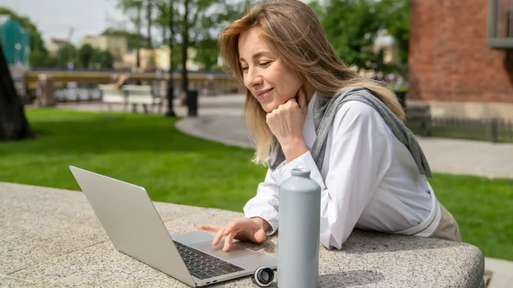 Person on a laptop outside at a table