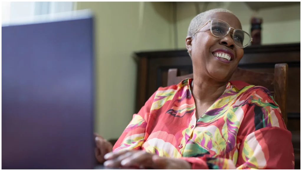 Resident smiling at a computer