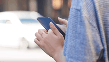 Close up of hands using a cell phone
